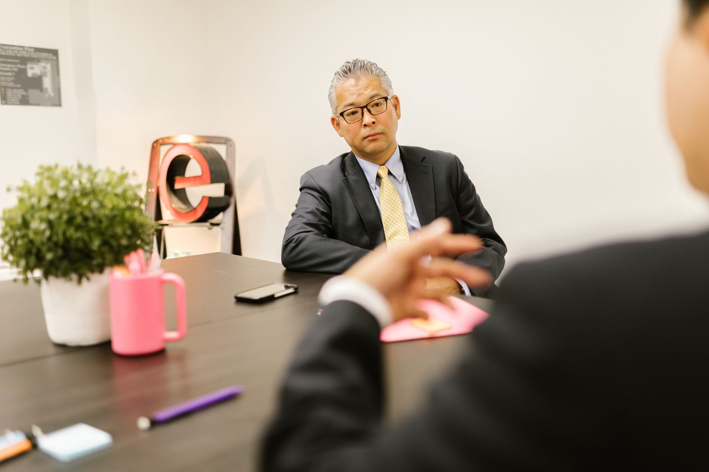 Two professionals talking during an office meeting