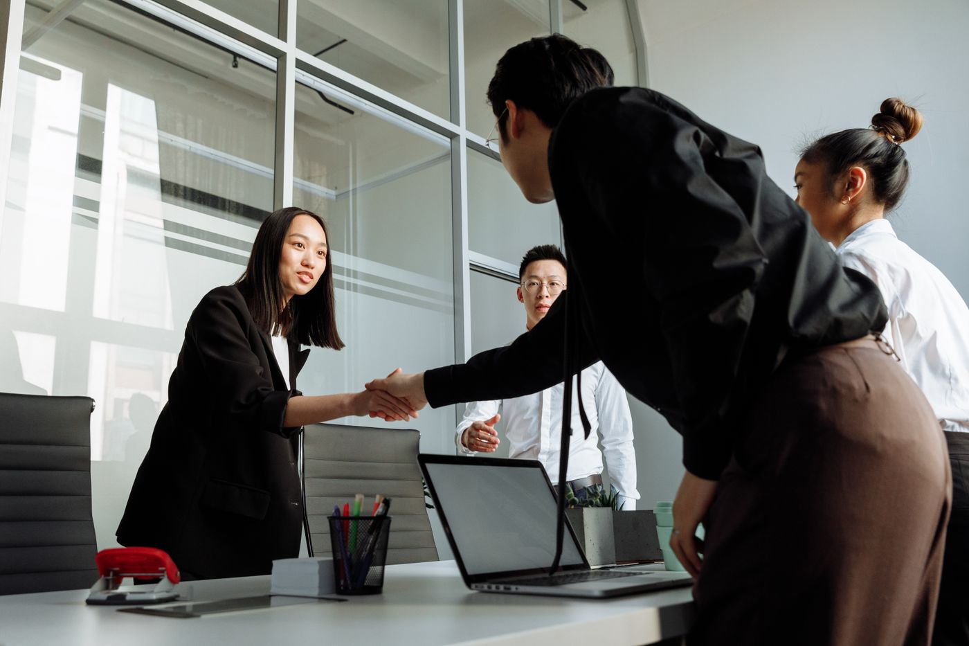 Business colleagues greeting each other in an office